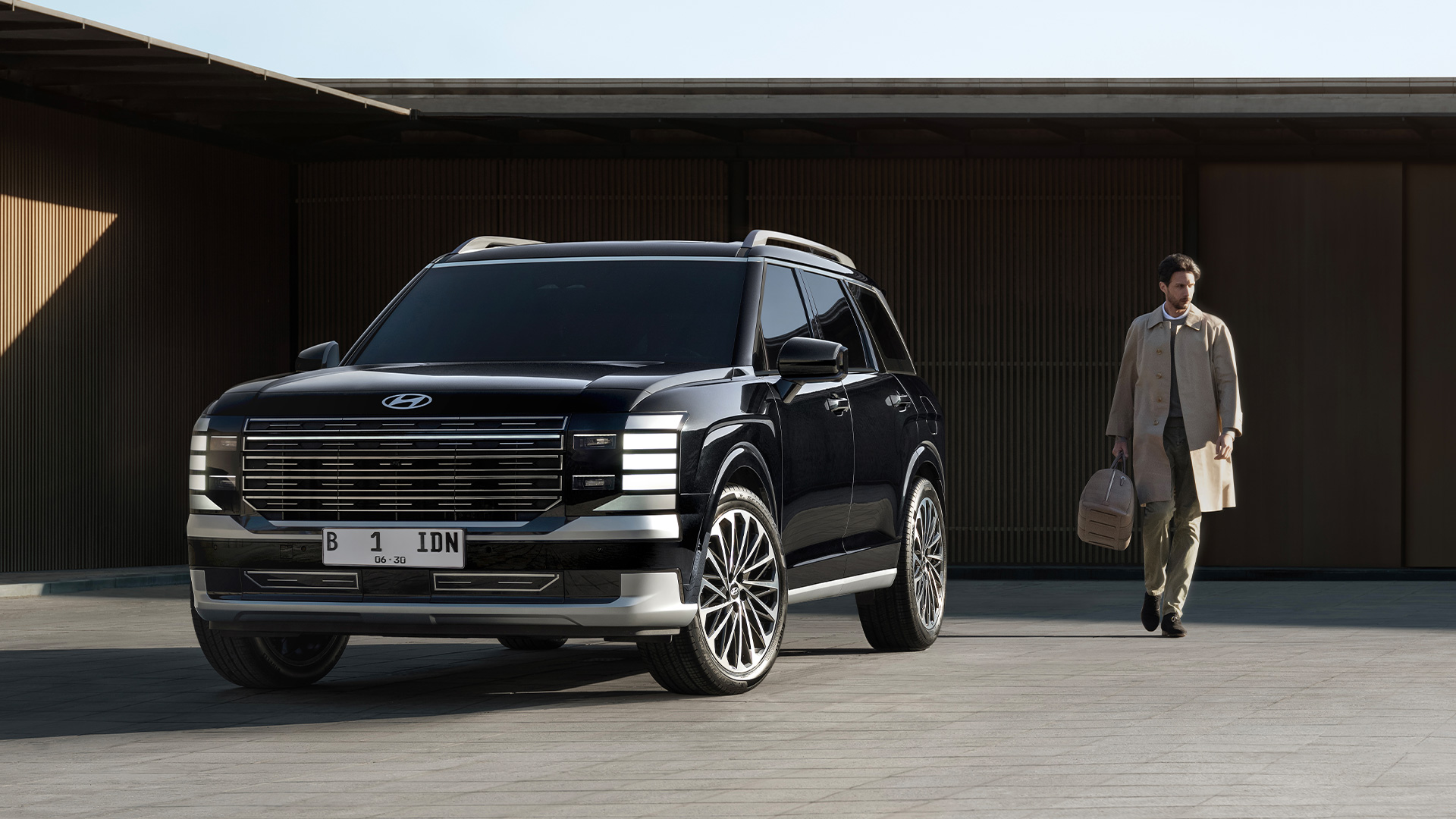 The all-new PALISADE side view, with city skyline