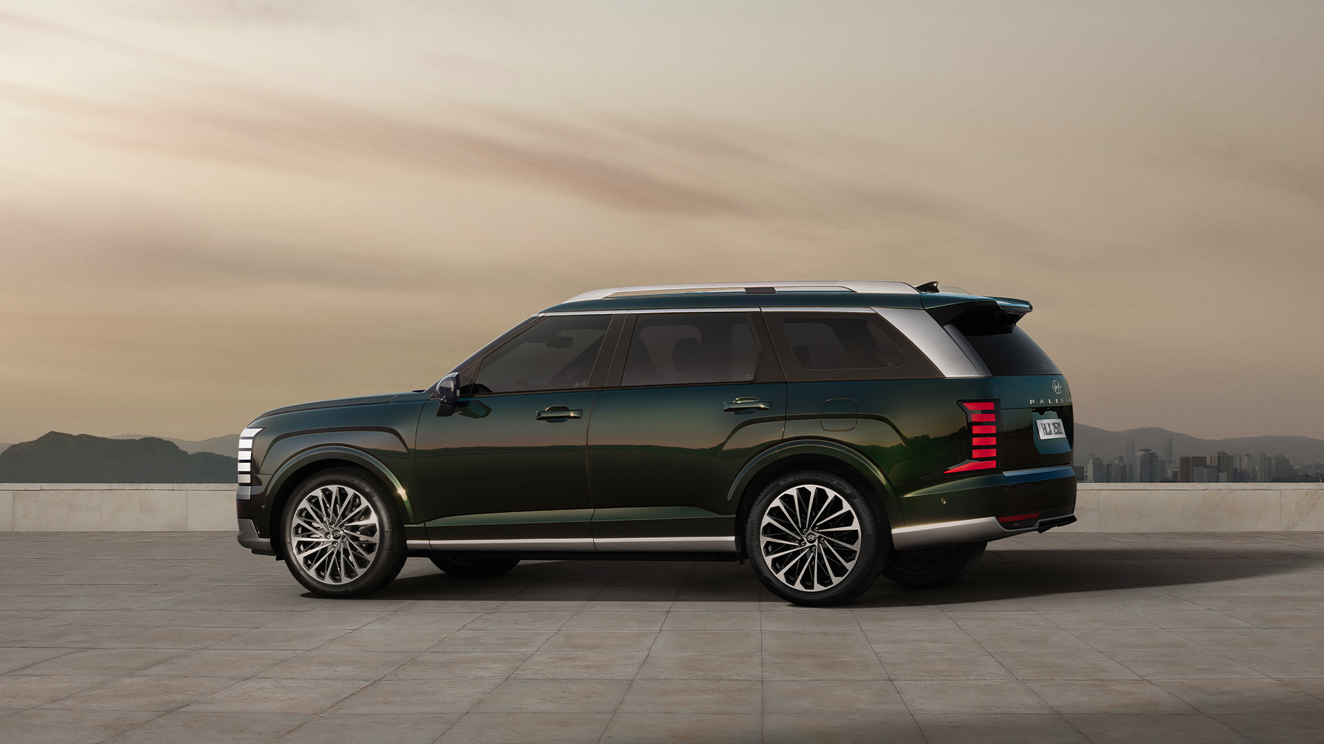 The all-new PALISADE side view, with city skyline