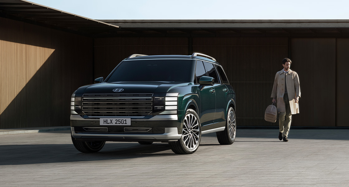 A man walking alongside with the all-new PALISADE