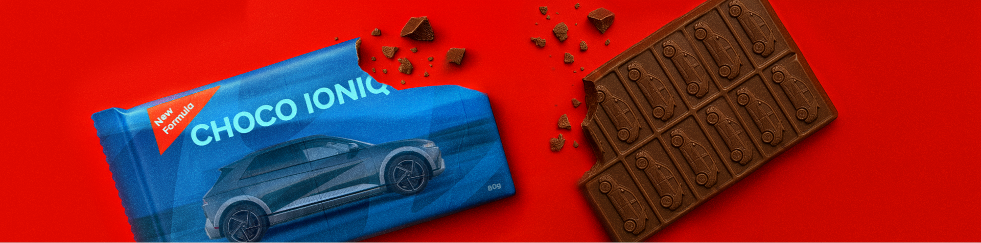A chocolate bar and an open wrapper, both featuring the image of a Hyundai IONIQ 5 printed on them.