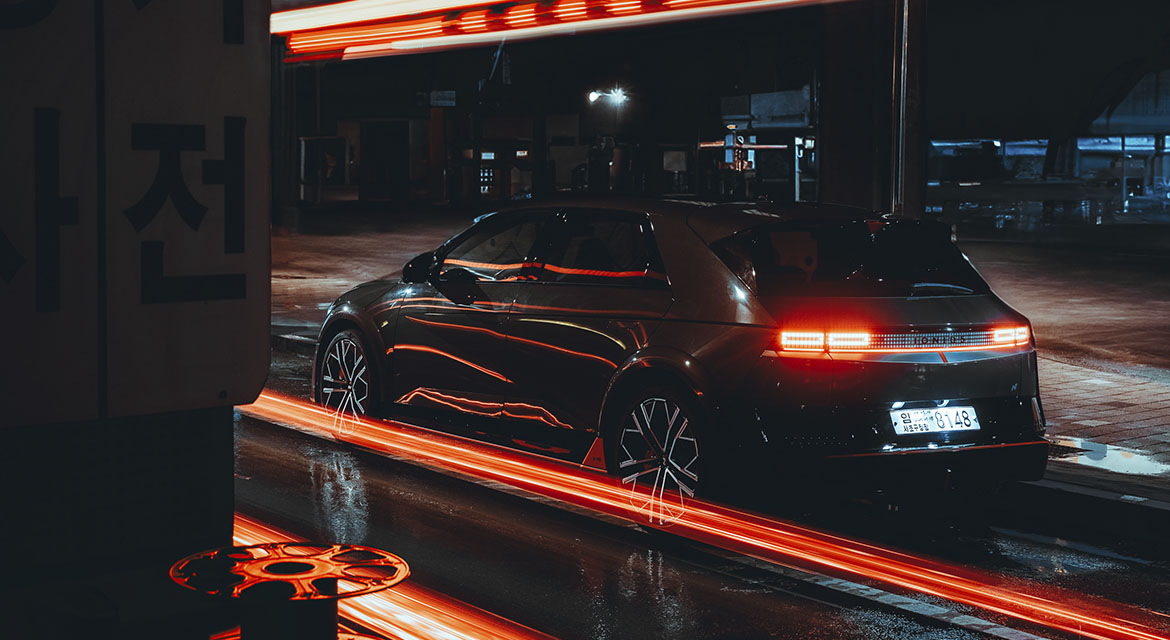 Contrasts in color are everywhere; Seoul's industrial buildings take on a different appearance under the reflected red glow of tail-lights