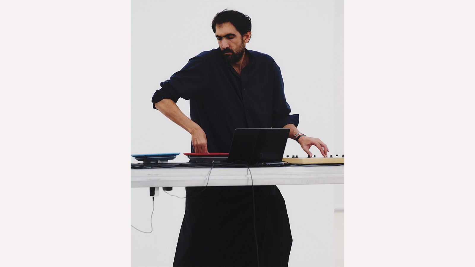 Tarek Atoui performs at the Issey Miyake Spring-Summer 2026 presentation at Centre Pompidou, Paris. October 2025. Photo © Luna Conte.