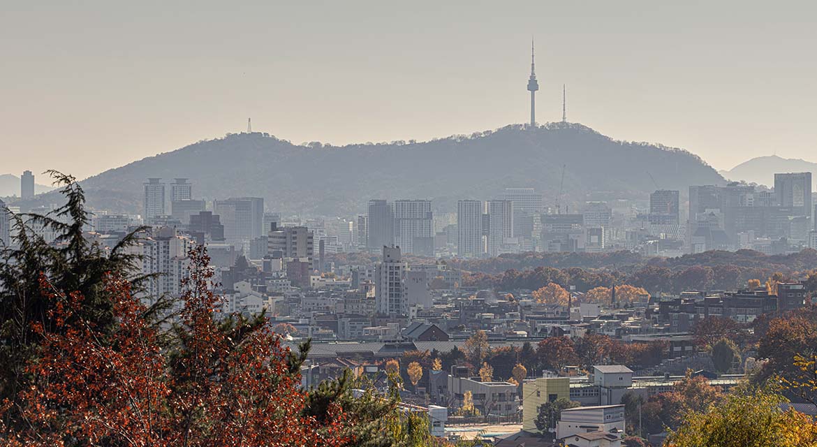 Seongbuk-gu stretches out below, with Namsan Seoul Tower visible on the horizon through the morning haze.
